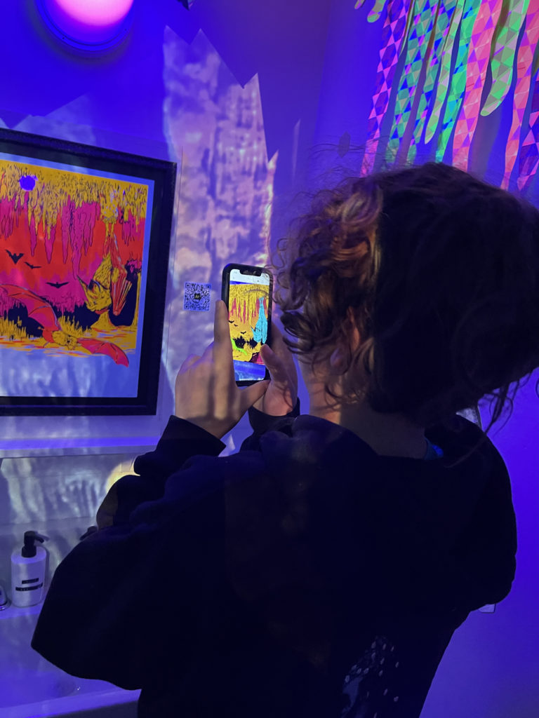 a person is using the AR experience in the museum